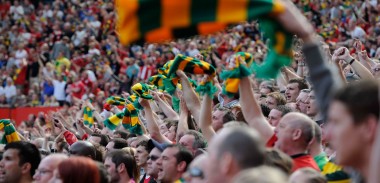Manchester United fans waves their Green and Gold Scarves
